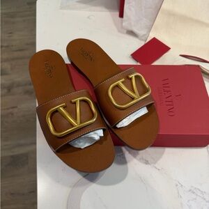 Valentino Garavani Tan Slides with Gold Logo V Emblem
